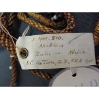 Rectangular parchment label tied to object