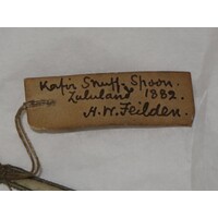 Rectangular brown paper label tied to object