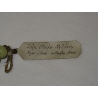 Rectangular parchment label tied to object